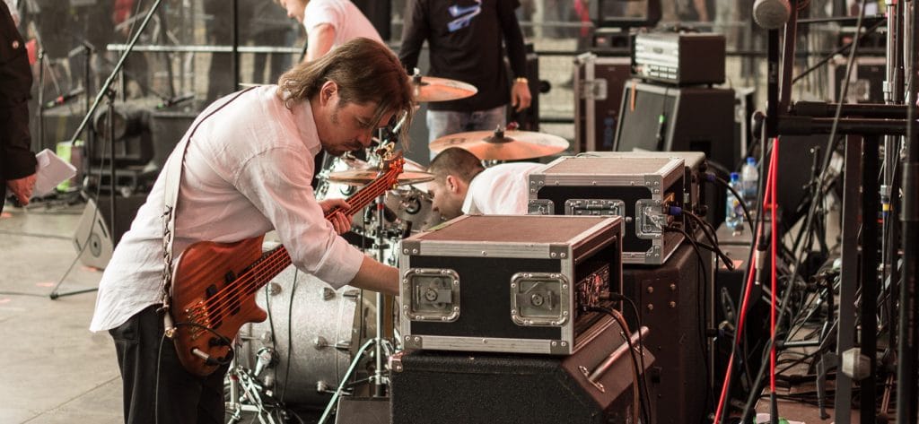 Bass Guitarist Preparing His Rack on Stage